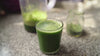 Adding spirulina to glass of healthy green vegetab